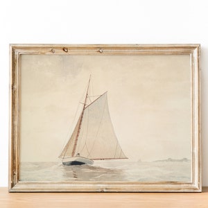May include: A framed watercolor painting of a sailboat with white sails on a calm sea. The painting is in a light wood frame with a white mat.