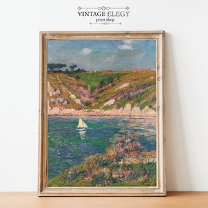 May include: A vintage painting of a seascape with a sailboat in the water. The painting is framed in a light wood frame and has a light blue sky with white clouds. The water is a deep blue with green and white waves. The shore is a mix of green and brown with a few trees.