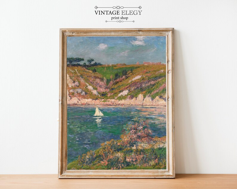 May include: A vintage painting of a seascape with a sailboat in the water. The painting is framed in a light wood frame and has a light blue sky with white clouds. The water is a deep blue with green and white waves. The shore is a mix of green and brown with a few trees.