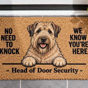 May include: A rectangular tan coir doormat featuring a brown terrier dog illustration. The text reads NO NEED TO KNOCK WE KNOW YOU'RE HERE and Head of Door Security. The dog is positioned in the center with its front paws resting on a black line.