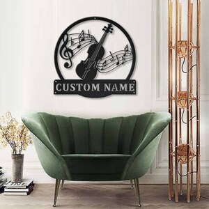 May include: Black metal wall art featuring a violin with musical notes and the text "CUSTOM NAME".