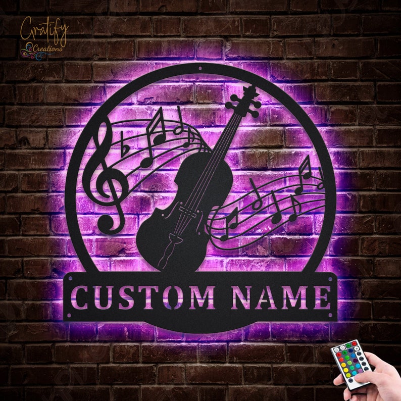 May include: A black metal wall art piece featuring a violin with musical notes and a treble clef. The art is illuminated with purple LED lights and has a custom nameplate that reads "CUSTOM NAME".