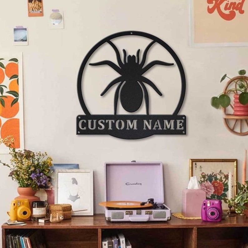 May include: Black metal wall decor featuring a spider silhouette inside a circle with the text "CUSTOM NAME" below.