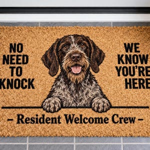 May include: A rectangular tan coir doormat featuring a brown and white wirehaired pointing griffon dog illustration. The text reads NO NEED TO KNOCK WE KNOW YOU'RE HERE and - Resident Welcome Crew - in black lettering across the textured surface.