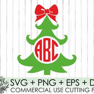 May include: A green Christmas tree with a red bow on top and a circle with the letters "ABC" inside. The tree is on a white wood background. SVG + PNG + EPS + DXF COMMERCIAL USE CUTTING FILES.
