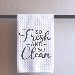 May include: White kitchen towel with the text "So Fresh And So Clean" printed in black.