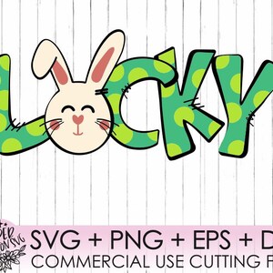 May include: A green and white polka dot design with the word "LUCKY" in a whimsical font. A white bunny with pink ears and a pink nose is in the centre of the design.