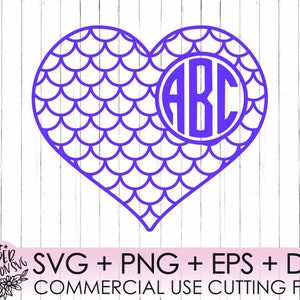 May include: A purple heart-shaped design with a mermaid scale pattern. The center of the heart has a circle with the letters "ABC" inside.