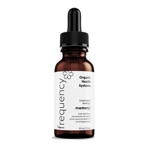 May include: A brown glass bottle with a black dropper top. The bottle is labeled "frequency" and contains "Organic Health Systems imprinted energy memory brain boosting aquamarine, focusing white peony & clarity of mind frequencies 30 ml (1 fl oz.)"