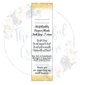 May include: A rectangular label with gold glitter at the top and bottom. The label features the text "Refillable Paper Mate Ink Joy .7 mm". Additional text provides care instructions and a thank you message for supporting a small business.