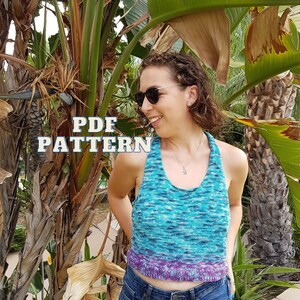 May include: A blue and purple halter top with the text "PDF PATTERN". The top is made of a knitted material and is worn with blue jeans. The top has a gradient effect, transitioning from blue to purple.