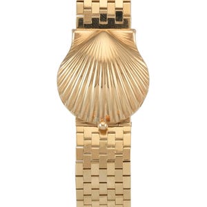 May include: A gold-tone wristwatch with a unique seashell-shaped face and a gold-tone metal band.