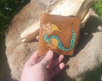 Handmade, one-of-a-kind leather wallet with engraved grotesque dragon design.
