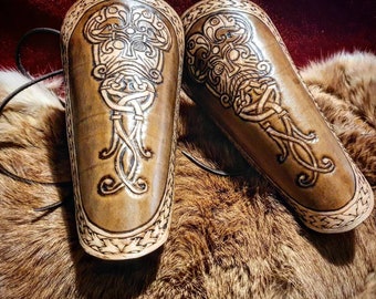 Pair of engraved leather armbands evoking Viking imagery with Odin mask motif, unique, handmade piece