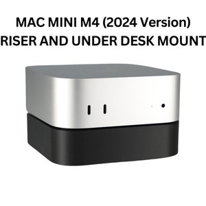 May include: A silver and black Mac Mini M4 (2024 Version) computer with a riser and under desk mount. The computer has two ports on the front.