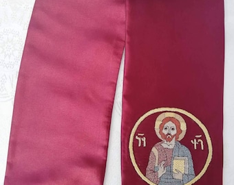 May include: Burgundy satin stole with gold trim and an embroidered image of a man in a circle with the text "??" on either side.
