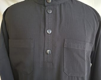 May include: A black long-sleeved shirt with a mandarin collar and four buttons down the front. The shirt has two pockets on the chest and a stitched design around the collar and pockets.