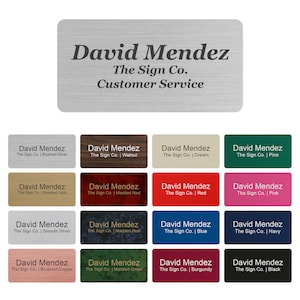May include: A collection of name tags with the text "David Mendez, The Sign Co., Customer Service." The tags come in various colors and finishes, including brushed silver, walnut, cream, pine, red, pink, and black.