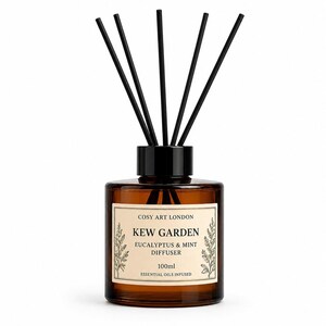 May include: A 100ml amber glass reed diffuser bottle with a black cap and five black reeds. The cream-colored label reads: COSY ART LONDON, KEW GARDEN, EUCALYPTUS & MINT DIFFUSER, 100ml, ESSENTIAL OILS INFUSED, featuring botanical illustrations on the sides.