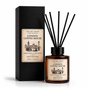 May include: A reed diffuser with a brown glass bottle and black reeds, accompanied by a tall black rectangular box. Both feature a cream-coloured label with the text COSY ART LONDON, LONDON COFFEE HOUSE, LIBRARY BOOK & DARK COFFEE, 100ml | 3.38 fl oz e.