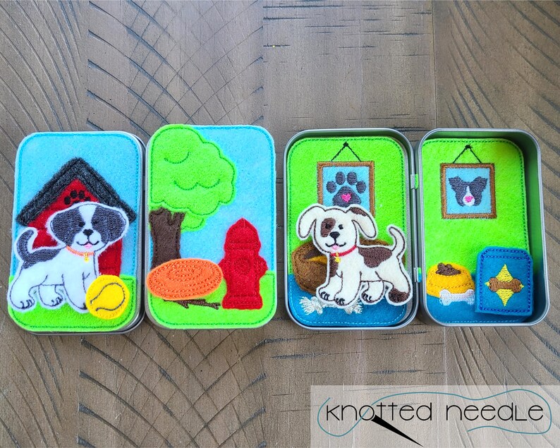 May include: Four small tin boxes with felt appliques of a dog in different scenes. The first box shows a dog in a red doghouse with a yellow ball. The second box shows a dog in front of a green tree and a red fire hydrant. The third box shows a dog in a green room with a picture on the wall. The fourth box shows a dog in a green room with a picture on the wall and a blue and yellow dog bed.