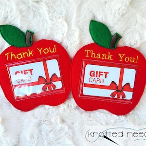 May include: Two red felt apple gift card holders with green felt stems and leaves. Each apple has a clear plastic window for a gift card and the text "Thank You!" and "Gift Card" in yellow thread.