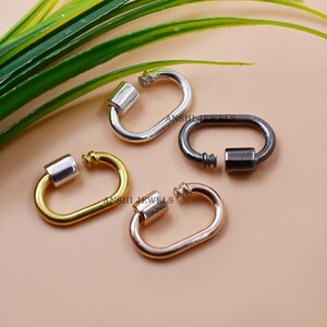 May include: Four different colored metal lobster clasps. The clasps are silver, gold, rose gold, and black. The clasps are oval shaped and have a spring loaded closure.
