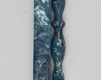 May include: A teal, white, and pink marbled pen blank and a matching pen with a clear tip.