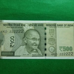 May include: A five hundred Indian rupee note featuring Mahatma Gandhi. The note has text in both English and Hindi, with the denomination clearly displayed. The serial number is 4KD 222222.