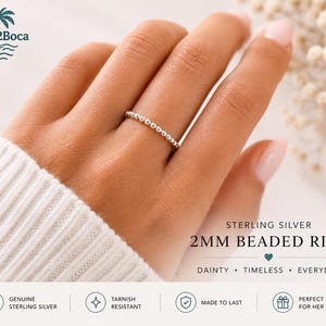 May include: A sterling silver ring featuring a continuous band of small 2mm beads. The text on the image reads: STERLING SILVER 2MM BEADED RING, DAINTY • TIMELESS • EVERYDAY, GENUINE STERLING SILVER, TARNISH RESISTANT, MADE TO LAST, PERFECT GIFT FOR HER.