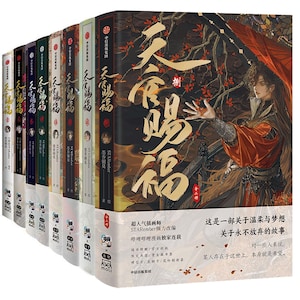 May include: A collection of hardcover books with colorful spines. The book covers feature illustrations of a person in orange and black clothing with long hair. The title is in gold lettering. Text in Chinese is also visible.