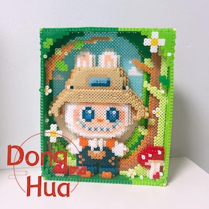 May include: A framed pixel art piece featuring a cartoon character with a straw hat, blue overalls, and a white face. The artwork is surrounded by a green frame with flowers and a mushroom. The text "Dong Hua" is in the lower left corner.