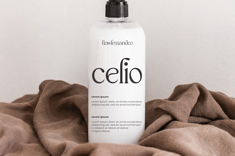 May include: White bottle with a black pump top and label. The label says "flawlessandco" and "celio". The bottle is sitting on a brown fabric surface. The label also includes the text "Lorem ipsum" and a short paragraph of text.