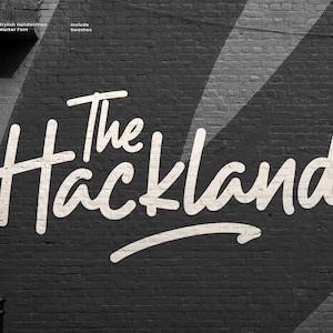 May include: A black and white image of a brick wall with the words "The Hackland" in a white, handwritten font. The text is the focal point, with additional text at the top and the right side of the image.