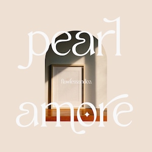 May include: White text on a beige background reads "pearl amore" with a decorative archway in the middle. Inside the archway is a wooden frame with a white mat and a blank white paper inside. The text "flawlessandco." is printed in the bottom right corner of the paper.