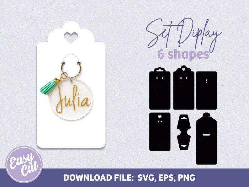 May include: A white card with a heart-shaped cutout at the top. A clear acrylic keychain with a gold tassel and the name "Julia" inscribed on it is attached to the card. The card is part of a set of six display cards for jewelry.