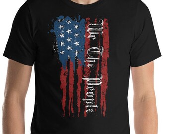 May include: A black t-shirt with a distressed American flag design and the text "We the People" printed vertically on the right side of the flag.