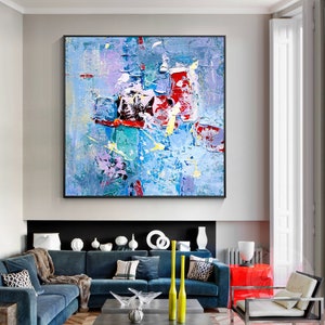 May include: Abstract painting with a blue, red, yellow, and white color scheme. The painting has a textured, layered look, with thick brushstrokes and visible paint.