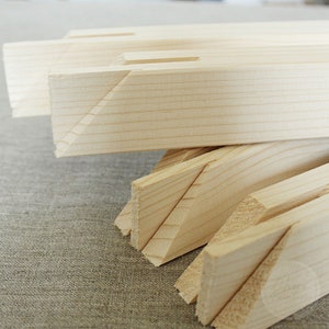 May include: Close-up of wooden stretcher bars for canvas, showing the mitered corners and natural wood grain.