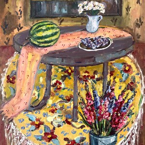 May include: An oil painting depicts a round table with a watermelon, grapes, and flowers. The table is covered with a yellow floral tablecloth and a pink runner. A shelf with vases and a bowl is in the background.