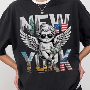New York Angel Statue Graphic Tee: Vintage City Skyline Oversized Shirt