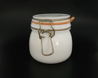 May include: White ceramic jar with a hinged lid and a metal latch. The lid has a light orange rubber seal.