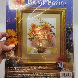 May include: A craft kit for bead embellishment featuring a framed picture of a floral still life. The kit includes pre-sorted glass beads, fabric, needle, and thread. The picture measures 8" x 10". The kit is from Design Works Crafts Inc.