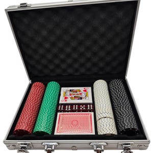 May include: A silver metal carrying case containing a poker set with four stacks of circular chips in red, green, white, and black. The set includes two decks of playing cards, one showing a king of hearts, and five translucent red dice.