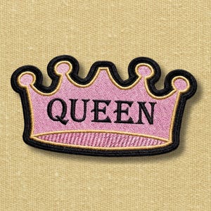 May include: A crown-shaped embroidered patch featuring a light pink centre with the word QUEEN stitched in black capital letters. The design is outlined with a thin gold border and a thick black outer edge, creating a distinct graphic shape.