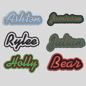 May include: Six embroidered name patches featuring cursive lettering. The names Ashton, Jamieson, Rylee, Julian, Holly, and Bear are displayed in various color combinations including light blue, green, black, white, and red with stitched borders.
