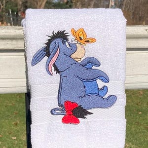 Blue Donkey Sitting with an Orange Butterfly on His Snout - Machine Embroidered on a White Hand Towel - 100% Cotton - Classic Cartoon Style