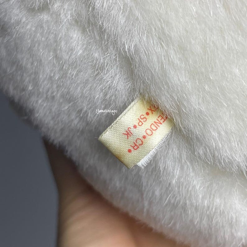 May include: A white plush toy with a yellow tag that reads "CR.F. ENDO. SP. JR. X".