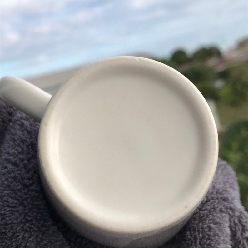 May include: White ceramic mug with a smooth, rounded bottom. The mug is empty and appears to be new.