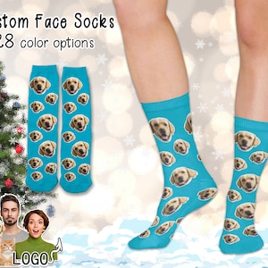 May include: A pair of blue socks with a repeated pattern of a dog's face. The socks are shown on a person's legs. The text "Custom Face Socks" and "28 color options" is shown at the top of the image.